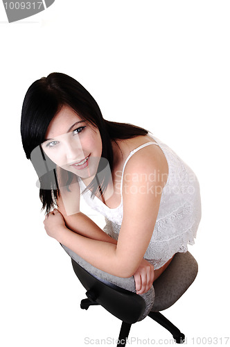 Image of Girl kneeling on chair.