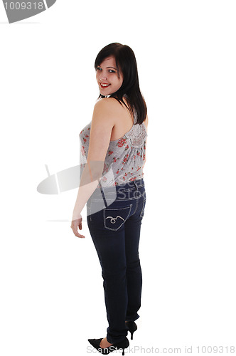 Image of Standing girl in jeans.