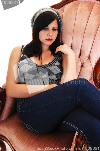 Image of Girl sitting in armchair.