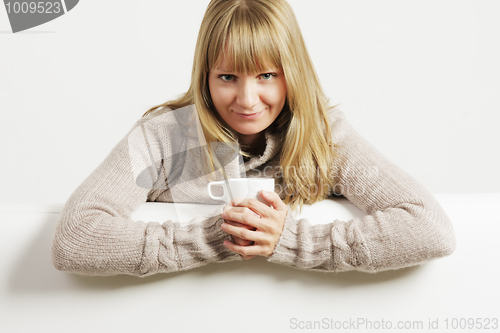 Image of Smiling woman with white cup