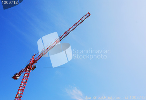 Image of red tower crane blue sky