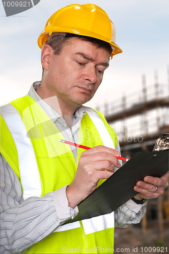 Image of Construction foreman checks clipboard