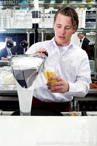 Image of bartender tapping beer 