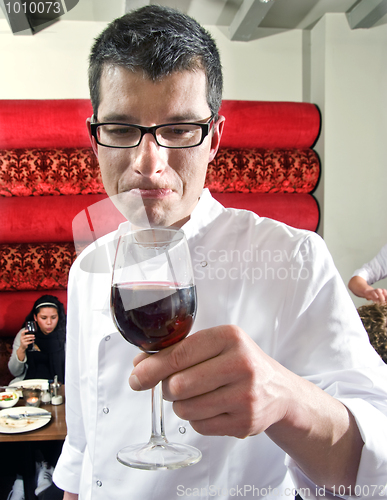 Image of wine waiter savouring wine