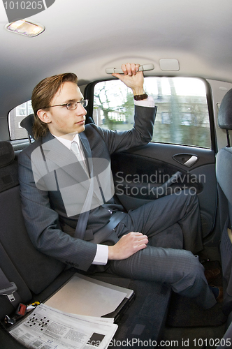 Image of Businessman in a taxi