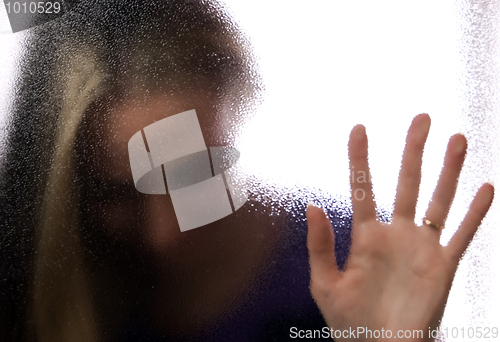 Image of A girl behind the glass   