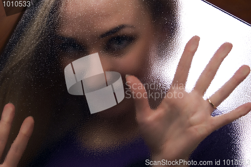 Image of Girl behind the glass  door