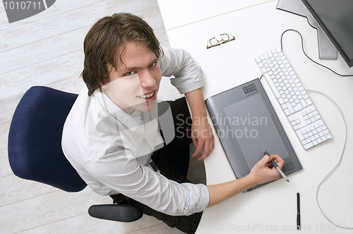 Image of Portrait of a man sitting behind a desk