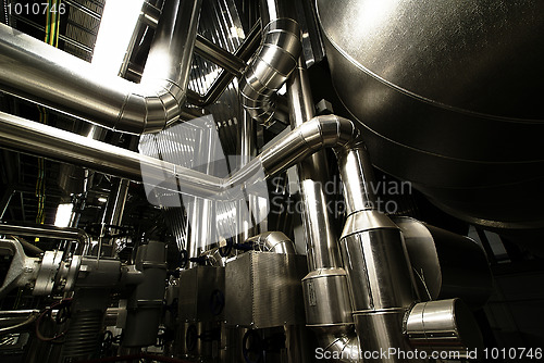 Image of different size and shaped pipes and valves at a power plant