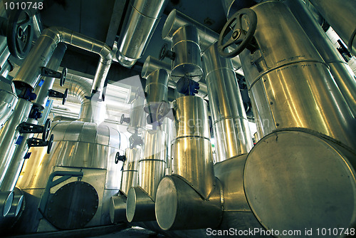 Image of different size and shaped pipes and valves at a power plant 