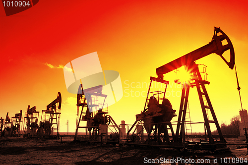 Image of working oil pumps silhouette in row