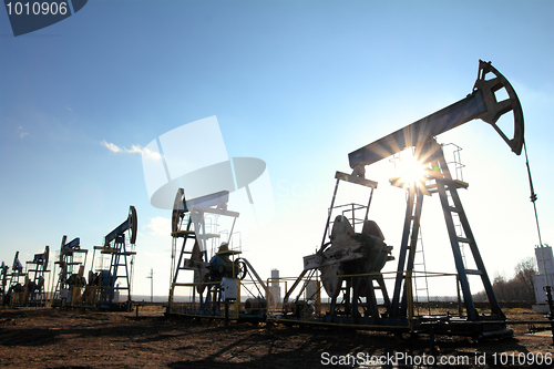 Image of working oil pumps silhouette in row