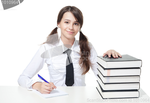 Image of Happy schoolgirl with stack of books