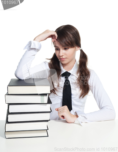 Image of Sad schoolgirl with books