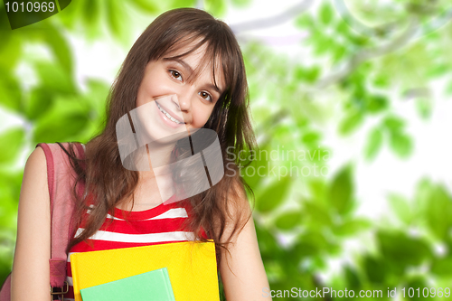 Image of Teenage girl with books outside