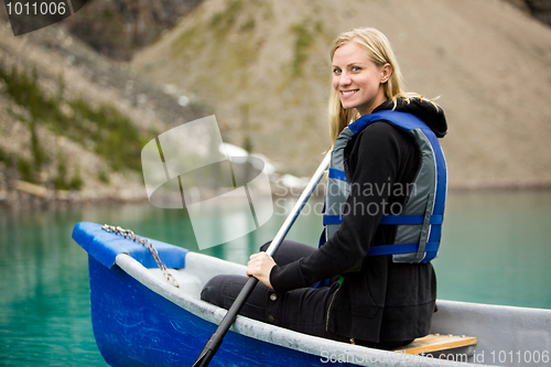 Image of Woman Canoeing on Lake