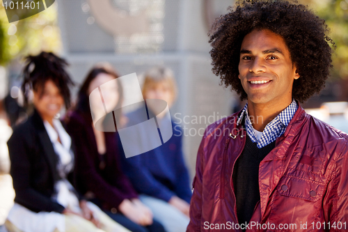 Image of Four People with One Man as Focal Point