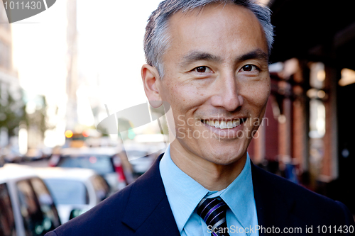Image of Middle Aged Businessman Standing Outside