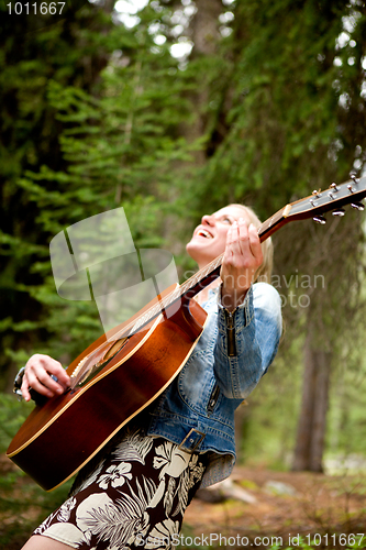 Image of Woman Singing Free in the Forest