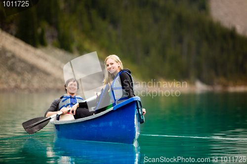 Image of Couple Canoeing and Relaxing