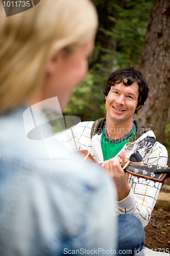 Image of Man Serenading a Woman with Guitar