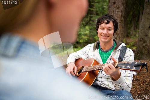Image of Man Playing Guitar for Woman