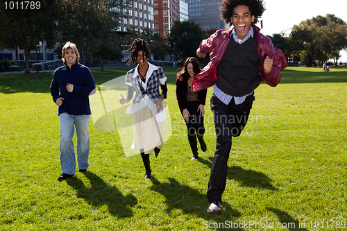 Image of Four People Running Through an Urban Park