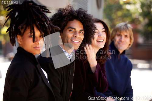 Image of Diverse Group of Four Friends Relaxing Together