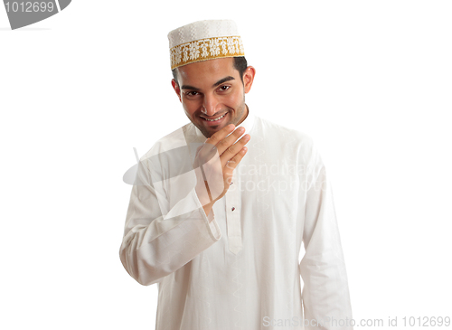 Image of Smiling ethnic man in traditional robe and topi