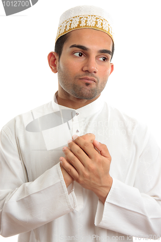 Image of Ethnic man holding his hands to his chest