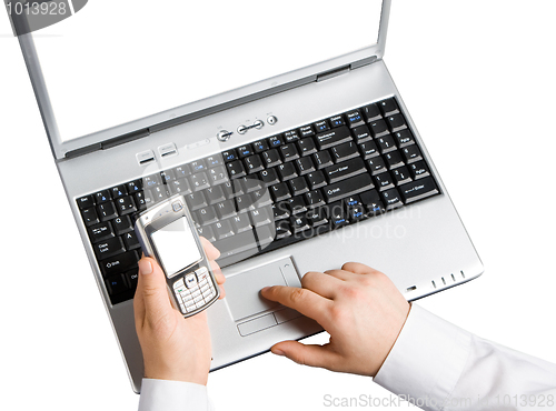 Image of Using a laptop and a mobile phone