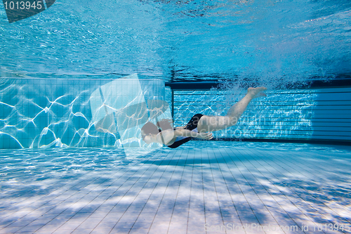 Image of Girl swims underwater after the jump