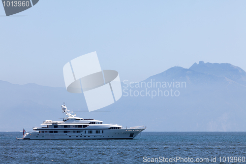 Image of Cruising yacht in the sea on the background of mountains