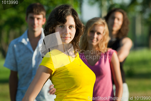 Image of A young girl stands in a park