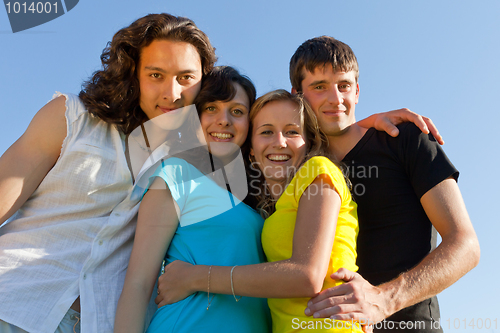 Image of Happy young people against the sky