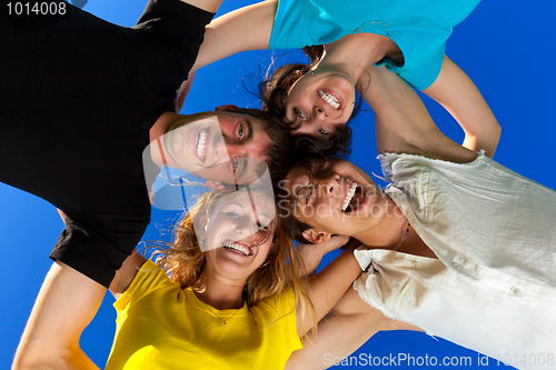 Image of The four friends, embracing, has formed a circle and bent over a