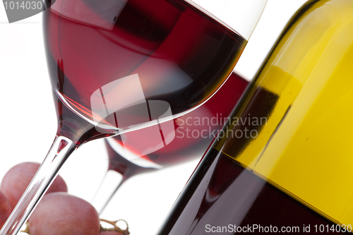 Image of Two glasses with dark red wine on a white background