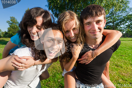 Image of Four young people having fun in the park