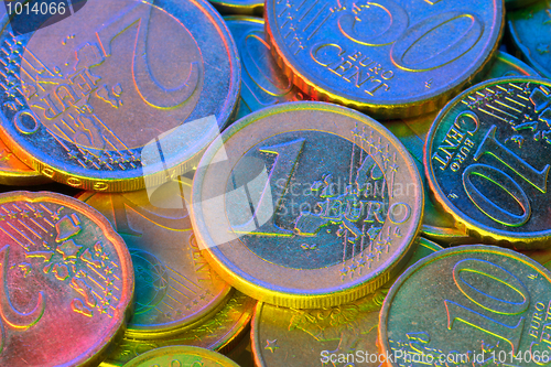 Image of Euro coins, illuminated by colored light