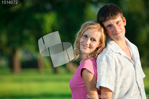 Image of A couple of lovers in the summer are in the park early in the ev