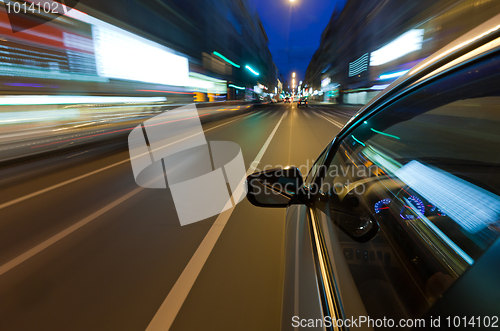Image of Car driving fast in the night city