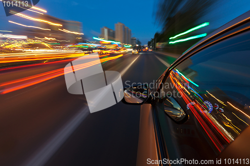 Image of Car driving fast in the night city