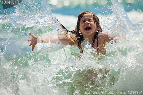 Image of Little girl at sea in sunny day