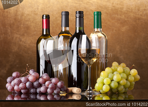 Image of Bottles, glasses and grapes
