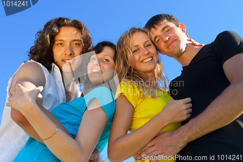 Image of Young people, two girls and two boys, hugged each other