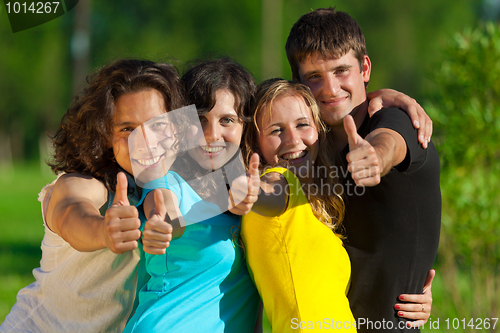 Image of Young group of happy friends showing thumbs up sign