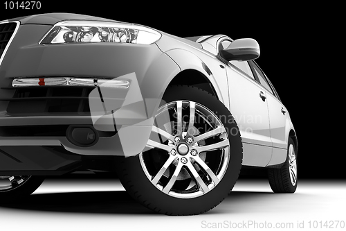 Image of Car front bumper, light and wheel on black