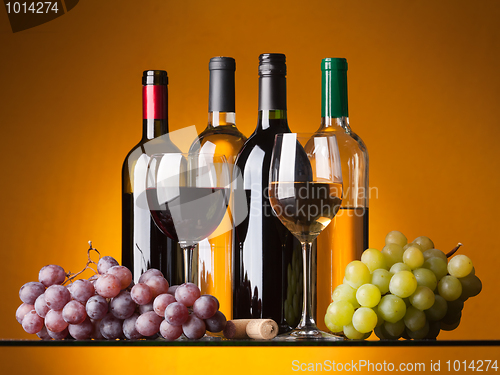 Image of Bottles, glasses and grapes