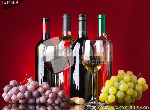Image of Bottles, glasses and grapes
