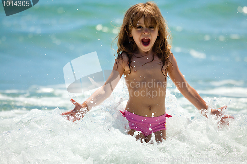 Image of Little girl at sea in sunny day